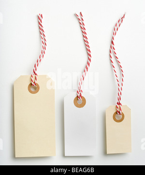 Three labels with red and white rope isolated on white Stock Photo