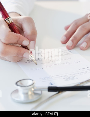 Doctor writing prescription Stock Photo