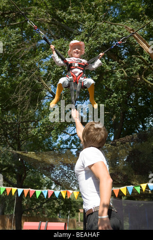 Little girl on bungee jumping. Stock Photo