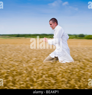 scientist running in a rye field with motion blur Stock Photo