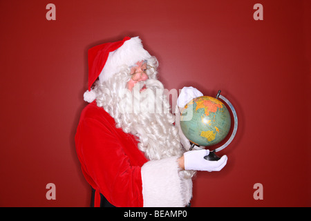Santa holding globe Stock Photo