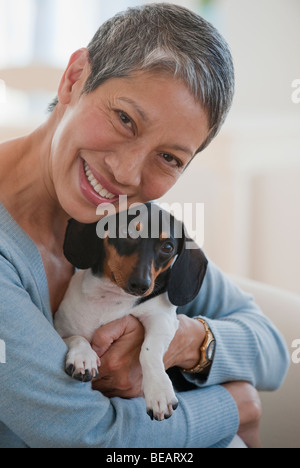 Chinese woman holding dachshund Stock Photo