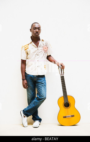 African man leaning on guitar Stock Photo