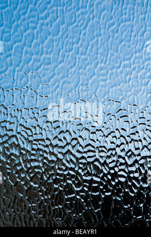 A bathroom textured glass window, providing privacy, without the need for curtains. Stock Photo