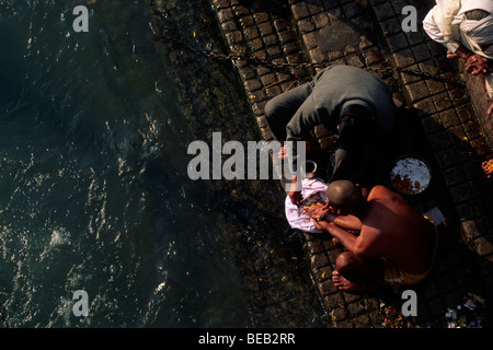 India, Uttarakhand, Haridwar, people giving offerings to the river Ganges Stock Photo