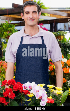 Man standing in a greenhouse and smiling Stock Photo
