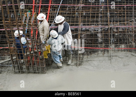 High angle view of four construction workers working at a construction site Stock Photo