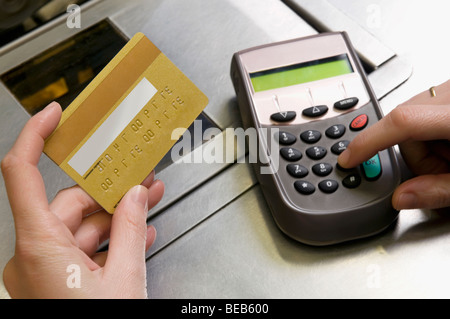 Close-up of a woman's hands using credit card reader Stock Photo