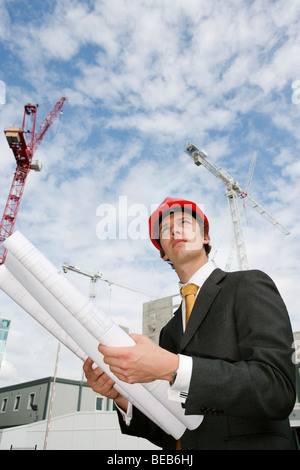 Executive manager on a building site with plans Stock Photo