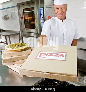 Chef holding a pizza box Stock Photo