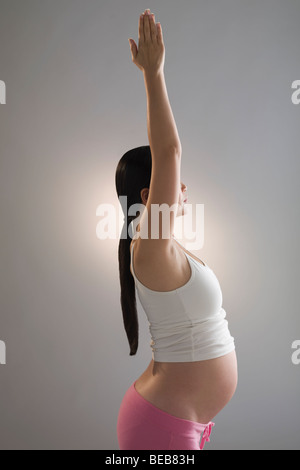 Pregnant woman practicing yoga Stock Photo
