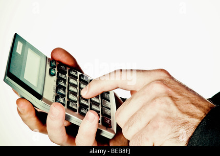 Close-up of a man's hand using a calculator Stock Photo