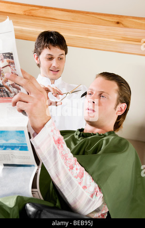 Man receiving a haircut in a salon Stock Photo