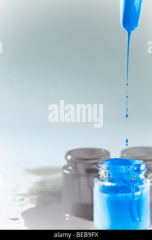 Paint dripping from a paintbrush Stock Photo
