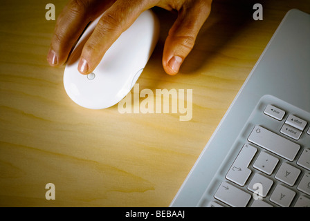 Close-up of a person's hand holding a computer mouse Stock Photo