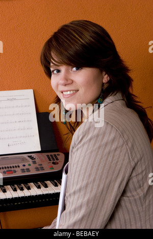 Teenage girl singing and playing piano Stock Photo: 48588812 - Alamy