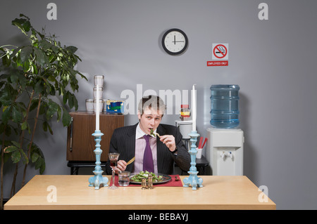 Portrait of a businessman having lunch in the office Stock Photo