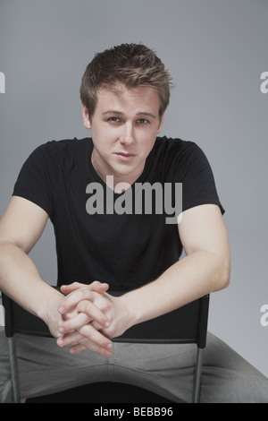Portrait of a man sitting on a chair Stock Photo