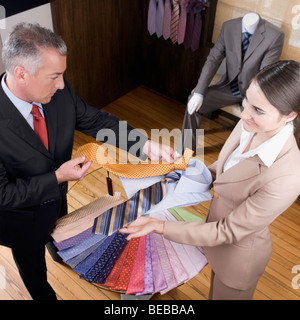 Saleswoman assisting a businessman in a clothing store Stock Photo