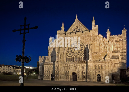 Exeter Cathedral At Night, with a crucifix in the foreground Stock Photo