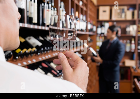 Businessman holding a wine glass Stock Photo