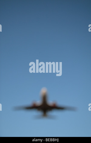An out of focus image of a plane coming in to land on the South Runway at London's Heathrow Airport, UK. Stock Photo