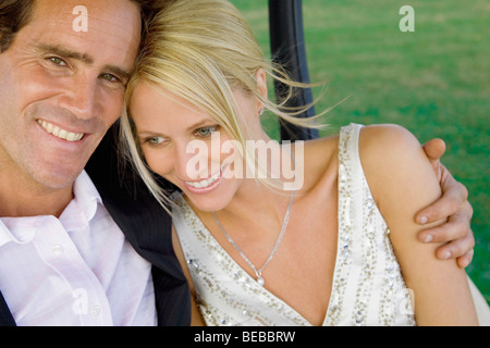 Couple sitting in a golf cart and smiling, Biltmore Golf Course, Coral Gables, Florida, USA Stock Photo