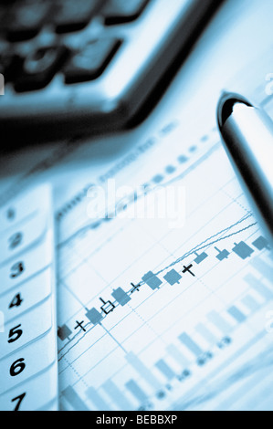 Pen and calculator on a graph Stock Photo