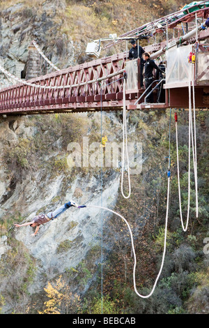 Naked man bungy jumping from a Kawarau suspension bridge Queenstown New