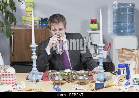 Businessman having lunch in the office Stock Photo
