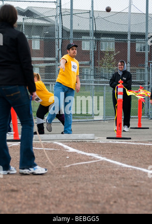 A young man throws a shot put during competition at the Special Olympics in Tacoma, Washington. Stock Photo