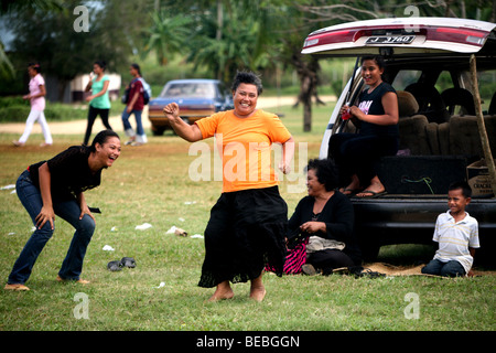 Tongan women brake into an impromtu dance after their team scores a try during a Saturday rugby match. Stock Photo