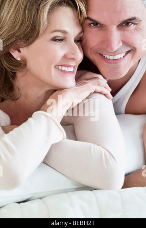 Couple lying on the bed and smiling Stock Photo