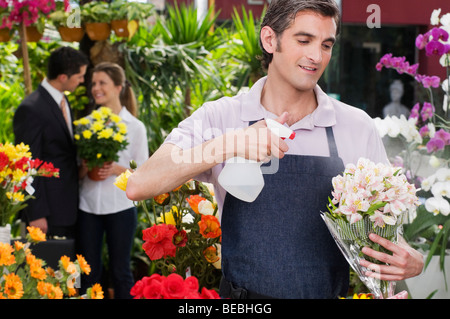 Florist working in a greenhouse Stock Photo