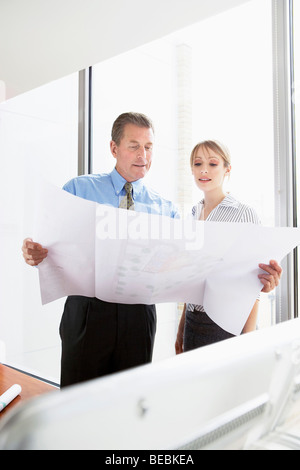 Architects looking at plans Stock Photo