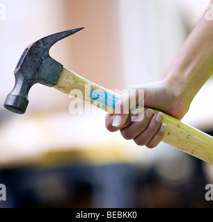 Detail of a woman's hand with hammer Stock Photo