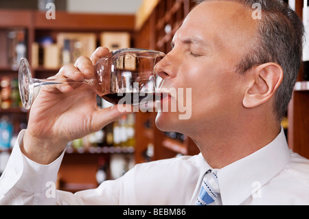 Businessman tasting wine in a cellar Stock Photo