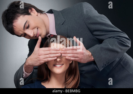 Close-up of a man covering a woman's eyes Stock Photo