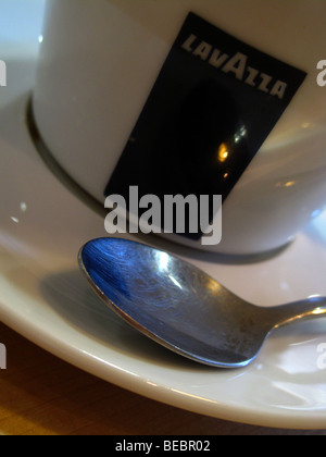 A spoon rests in the saucer of a Lavazza coffee cup in a coffee shop in Canterbury, Kent. Stock Photo