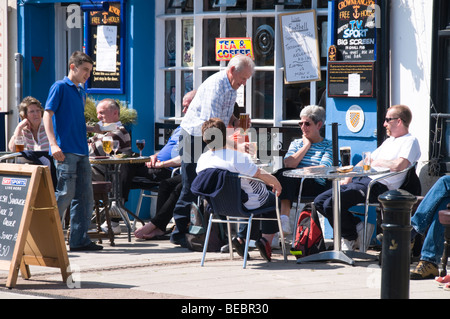 People enjoying their drinks outside pub, Brixham, Devon, UK Stock Photo