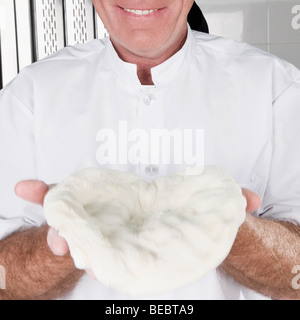 Chef holding pizza dough Stock Photo