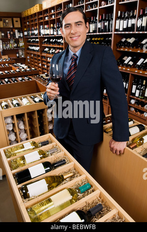 Businessman tasting wine in a cellar Stock Photo