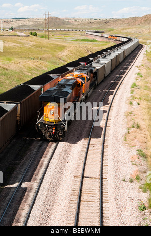 rail cars loaded with coal being transported by train from nearby mines to power plants in Wyoming Stock Photo