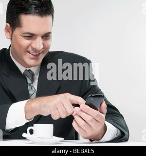 Businessman text messaging on a mobile phone Stock Photo