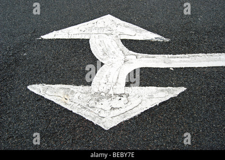 british double arrow head road marking indicating traffic can turn left or right Stock Photo