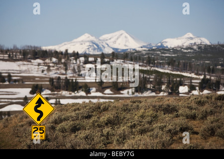 Curve in road sign with mountains in the background, Norris, Madison County, Montana, USA Stock Photo