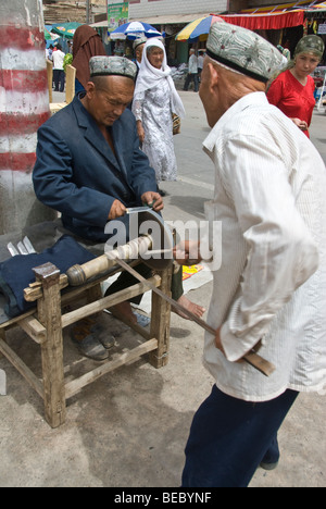 Chinese Blacksmith in a market of Kashgar, Xinjiang Province, China 2008. Stock Photo