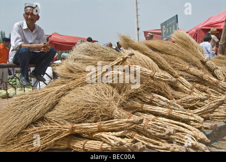 Broom vendor in a street market of Kashgar, Xinjiang Province, China 2008. Stock Photo