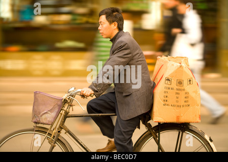 Man riding a bike in font of the markets of Yuyuan Gardens, Old Town, Shanghai, China, Asia Stock Photo