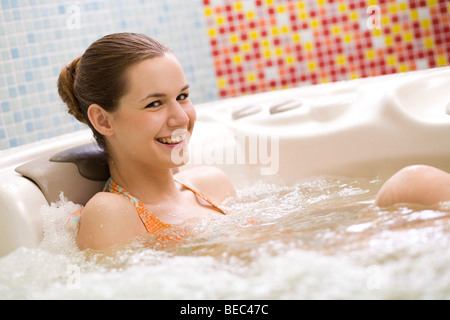 Young woman relaxing in whirlpool. Stock Photo